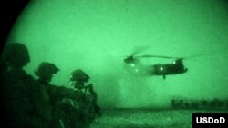 U.S. soldiers watch an air assault mission at night in Khost Province earlier this month.