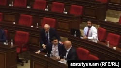 Armenia - Investigative Committee chief Argishti Kyaramian (left) and parliament deputy Hovik Aghazarian argue during a parliamentary hearing, Yerevan, Octobner 15, 2024.