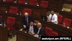 Armenia - Investigative Committee chief Argishti Kyaramian (left) and parliament deputy Hovik Aghazarian argue during a parliamentary hearing, Yerevan, Octobner 15, 2024.