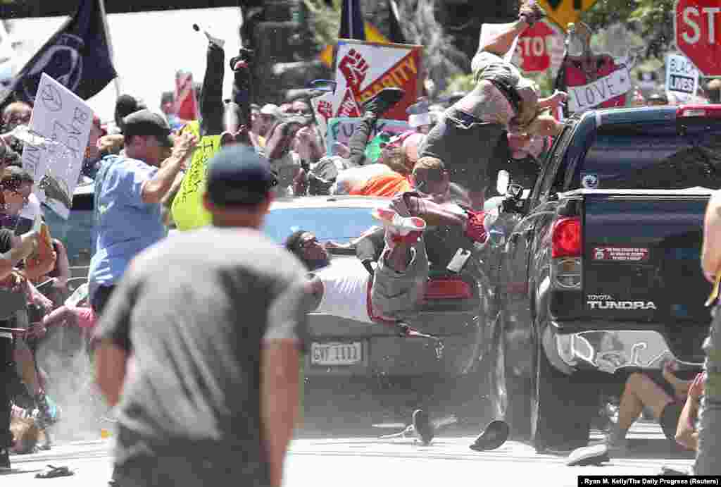 People are thrown into the air as a car plows into a group of protesters demonstrating against a Unite The Right rally in Charlottesville, Virginia, killing one person and injuring dozens more. Spot News -- Second Prize, Singles (Ryan M. Kelly, The Daily Progress)