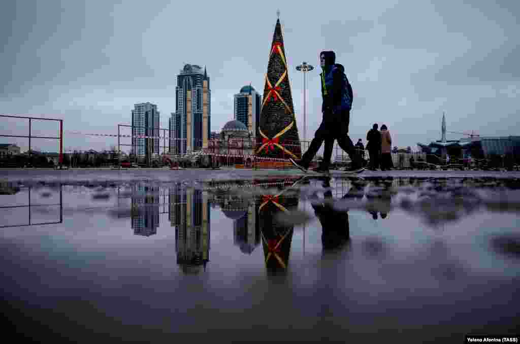 A Christmas tree is seen against the background of the Grozny City towers and the Akhmad Kadyrov Mosque in Grozny, Chechnya. (TASS/Yelena Afonina)