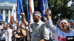 Opposition supporters shout slogans during a protest in front of the Ukrainian parliament in Kyiv on July 30.