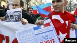 France -- Franco-Turkish protesters, one draped in a Turkish flag, demonstrate near the Senate in Paris, 23Jan2012