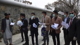 Activists wearing face masks prepare for a campaign to raise awareness of the new coronavirus in Kabul on  March 16.