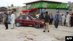 Pakistani police stand guard at the site of an attack by gunmen in Quetta on March 29.