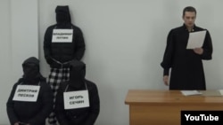 The video features Karim Yamadayev dressed as a judge reading death sentences.