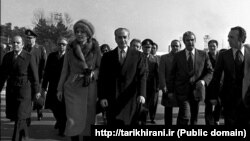 FILE - In this Jan. 16, 1979 file picture, Shah Mohammad Reza Pahlavi and Empress Farah walk on the tarmac at Mehrabad Airport in Tehran to board a plane to leave Iran.