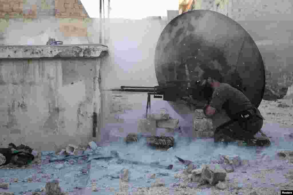 A member of the Free Syrian Army shoots back at a sniper during clashes with pro-government forces in Aleppo. (Reuters/Muzaffar Salman)