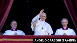 Pope Francis (center) delivers the traditional Urbi et Orbi Christmas Day blessing from the central balcony of St. Peter's Basilica in the Vatican on December 25.