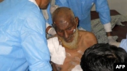 Medical staff treat a victim following twin bomb attacks in northwestern Pakistan.