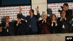 Turkey - Newly elected Turkish president Recep Tayyip Erdogan (C) and his wife Ermine wave at supporters from the balcony of the AKP party headquarters during the celebrations of his victory in the presidential election vote in Ankara on August 10, 2014