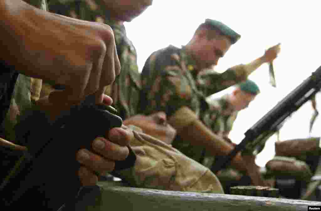 Guards load their weapons before going out on patrol.