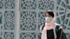 An Iranian woman wearing face mask walks on a street in Tehran, March 2, 2020