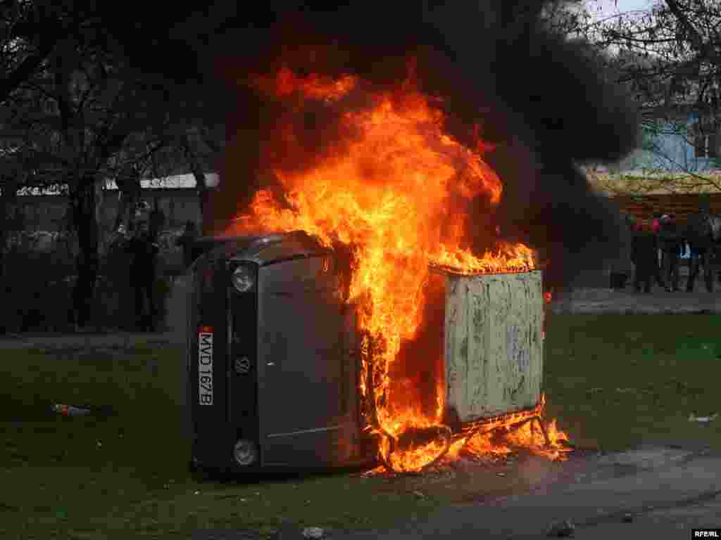 A car burns near the presidential administration building in Bishkek.