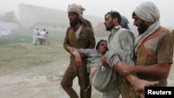 Since 2003, more than 50,000 civilians, militants, and soldiers have died in attacks by militants and Pakistani military sweeps across FATA. The fighting also displaced more than 3 million civilians. Men carry a displaced resident of North Waziristan, in Bannu, Khyber Pakhtunkhwa in June 2014. He fainted while queuing up for food supplies (file photo).