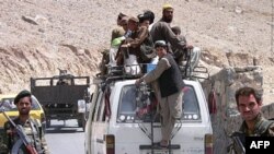 Afghan soldiers standing guard at a checkpoint