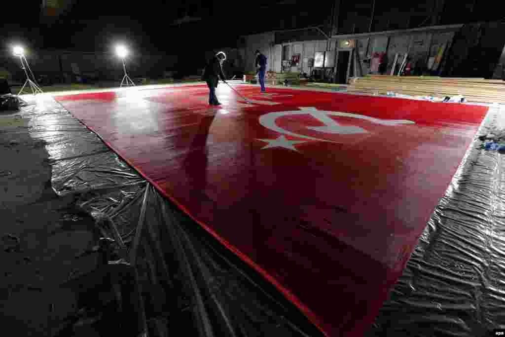 Employees cleans a giant replica of the Soviet Banner of Victory at St. Petersburg's Lenfilm film studio. (epa/Anatoly Maltsev)