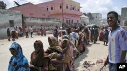 People displaced by drought wait to receive food aid in Mogadishu on July 25 amid the worst drought that east Africa's seen in six decades.