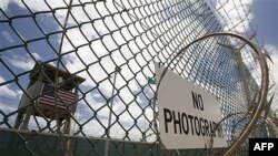 An outer fence and guard tower at the prison camp at Guantanamo Bay