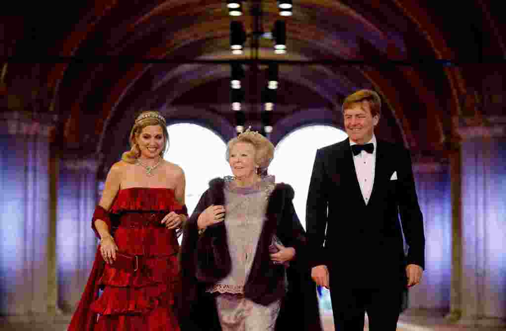 Queen Beatrix of the Netherlands (center) and Crown Prince Willem-Alexander and his wife, Crown Princess Maxima, leave the Royal Palace in Amsterdam. Queen's Day on April 30 will also mark the abdication of Queen Beatrix and the investiture of her eldest son, Willem-Alexander. (Reuters/Dylan Martinez)