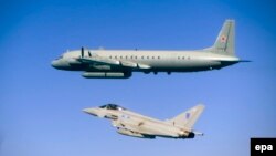 A Royal Air Force Typhoon jet (bottom) accompanies a Russian Ilyushin Il-20M electronic-intelligence-gathering aircraft over the Baltic Sea north of Kaliningrad.