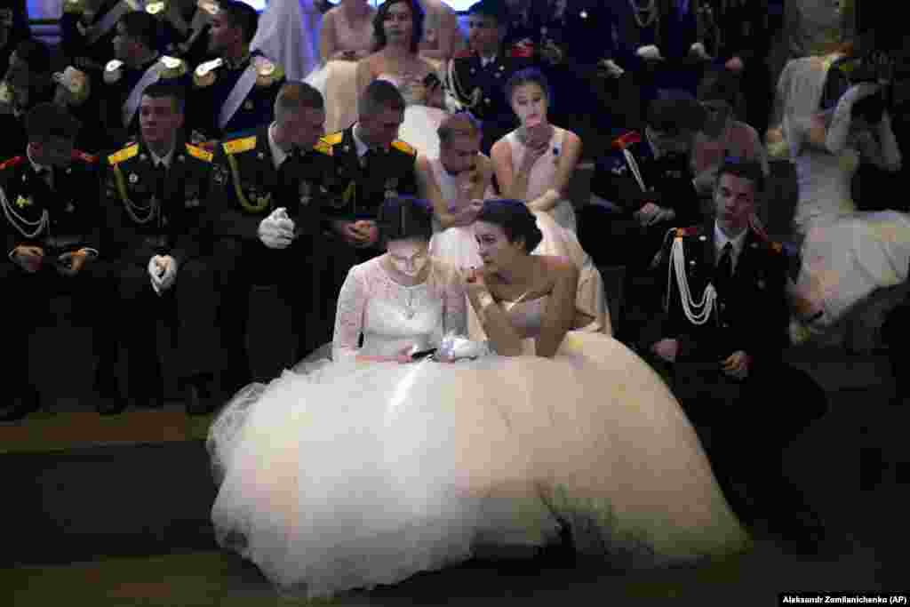 Students of military schools rest after dancing during an annual ball in Moscow. More than 1,000 students from military schools traveled from all over Russia to Moscow to take part in the ball. (AP/Alexander Zemlianichenko)