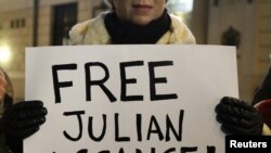 A protester holds a banner in support of Julian Assange during a demonstration in Budapest.