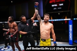 Amosov being announced the winner of his UFC debut fight on December 13 by way of an anaconda choke.