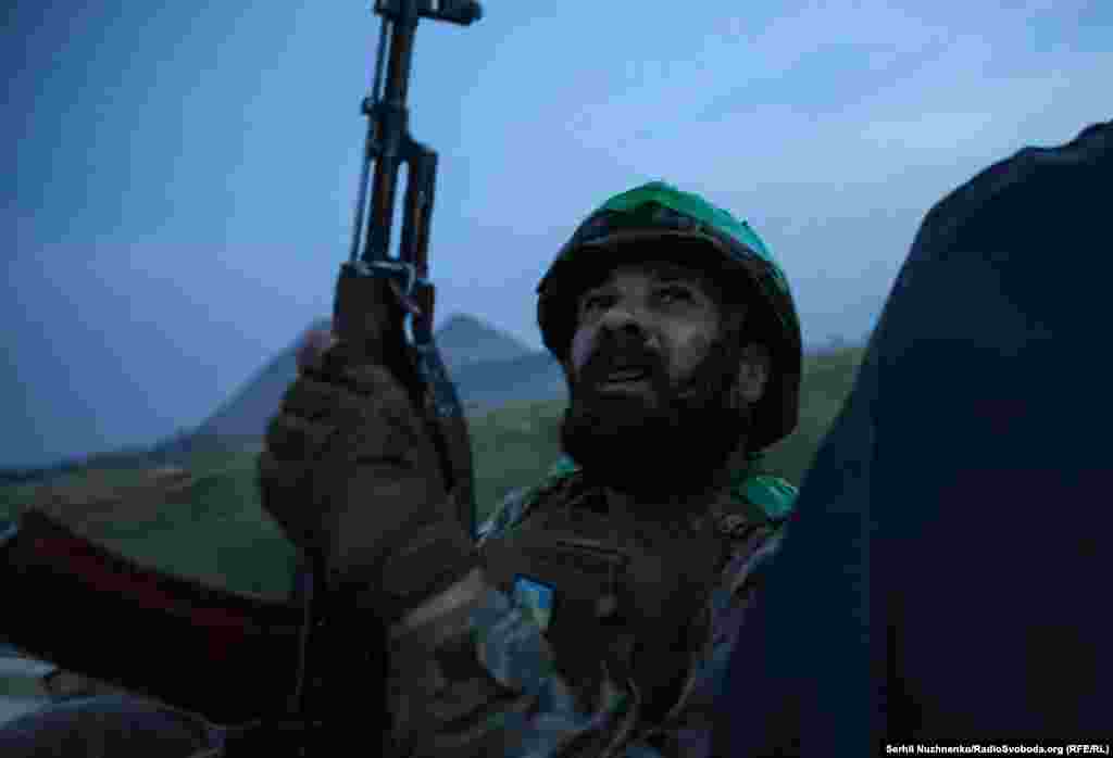 A Ukrainian soldier anxiously watches the skyline near the front line in the Donetsk region.&nbsp;