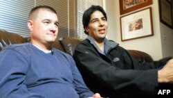 U.S. Army Captain Matt Zeller (left) with translator Janis Shenwari, whom he credits for saving his life in Afghanistan in 2008, during an interview in 2013 in Arlington, Virginia, after Shenwari received a special immigrant visa.