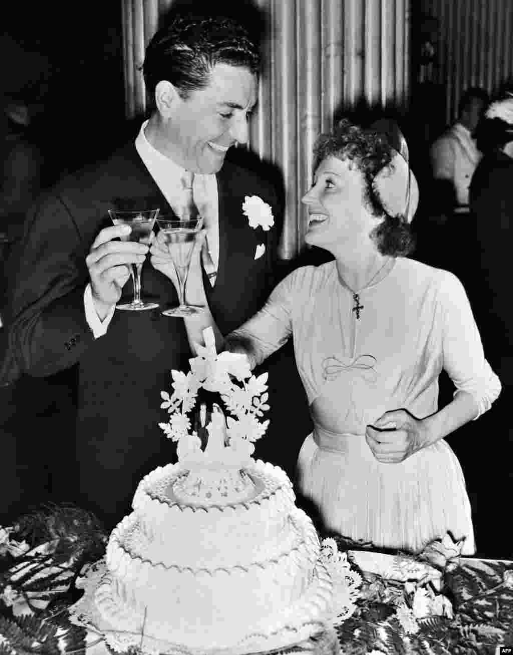 Piaf and Jacques Pills toasting at their wedding in New York on July 29, 1952.