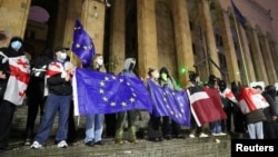 Supporters of Georgia's opposition parties protest in Tbilisi on December 2 against the government's decision to suspend talks on joining the European Union. 