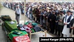 Relatives attend the funeral of five members of the same family a day after they were killed in a bomb blast in Kabul on March 22, just a few of the more than 300 people killed in March. 