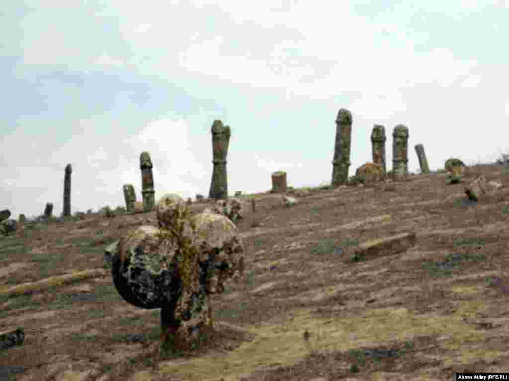 In recent years, this ancient monument has begun to deteriorate. A photograph taken just a few years earlier shows many more gravestones, including what is believed to be a female symbol, representing ovaries.