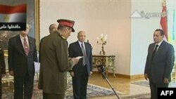 An image grab taken from Egyptian state television Al-Masriya shows members of Egypt's new cabinet being sworn in by Egyptian President Hosni Mubarak (right) in Cairo.