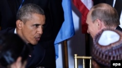 U.S. President Barack Obama (left) talks with his Russian counterpart Vladimir Putin at a luncheon during the UN General Assembly in New York on September 28. 