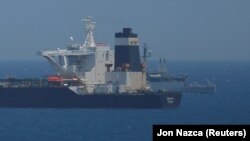 A British Royal Navy patrol vessel guards the oil supertanker Grace 1, that's on suspicion of carrying Iranian oil to Syria, as it sits anchored in waters of the British overseas territory of Gibraltar. July 4, 2019