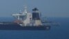 A British Navy patrol vessel guards the oil supertanker Grace 1 in Gibraltar territorial waters.