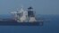 A British Navy patrol vessel guards the oil supertanker Grace 1 in Gibraltar territorial waters.