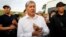 Almazbek Atambaev meets with journalists outside his compound in the village of Koi-Tash near Bishkek on June 27, 2019.