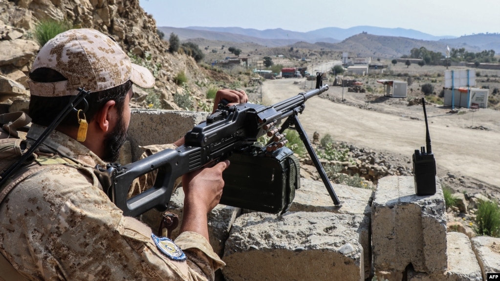 A Taliban soldier guards a road near the Ghulam Khan zero-point border crossing between Afghanistan and Pakistan in Gurbuz district in the southeast of Khost Province on October 20, 2025.