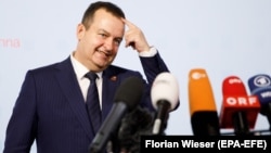 Serbian Foreign Minister Ivica Dacic talks to the media as he arrives for an informal meeting of foreign affairs ministers at the Hofburg Palace in Vienna on August 31.