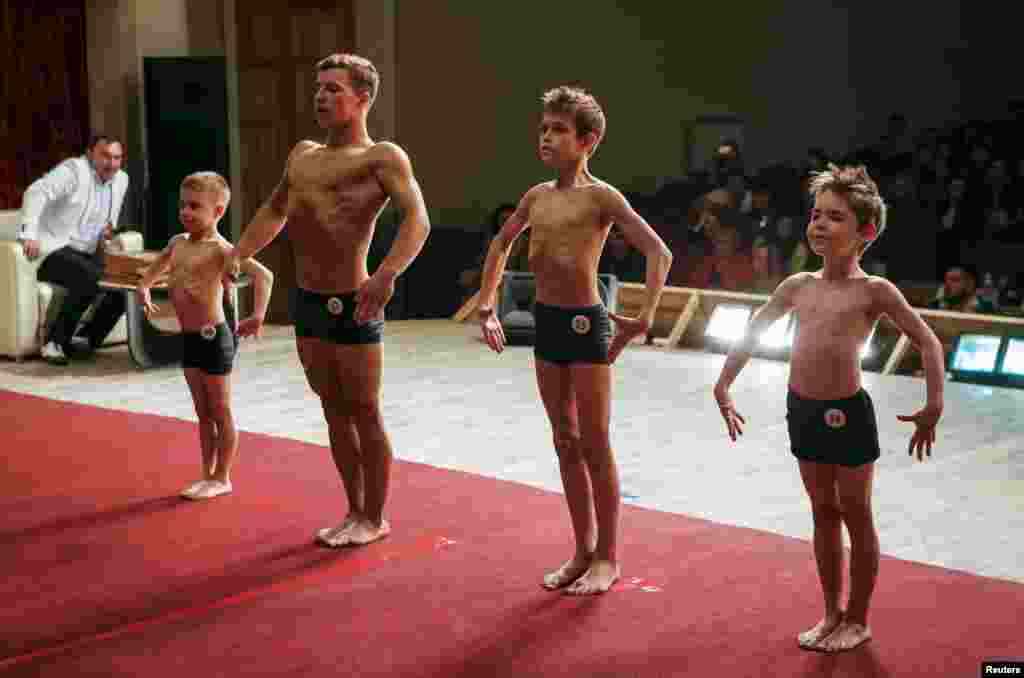 Junior participants pose during a regional bodybuilding championship in Stavropol, southern Russia. (Reuters/Eduard Korniyenko)