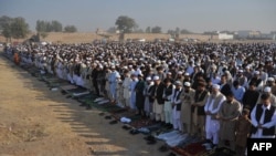 Waiting for peace: Afghan refugees at Eid al-Adha prayers in Peshawar in November