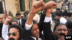 Antigovernment lawyers shout slogans during a protest before the start of a long march in Karachi on March 12.