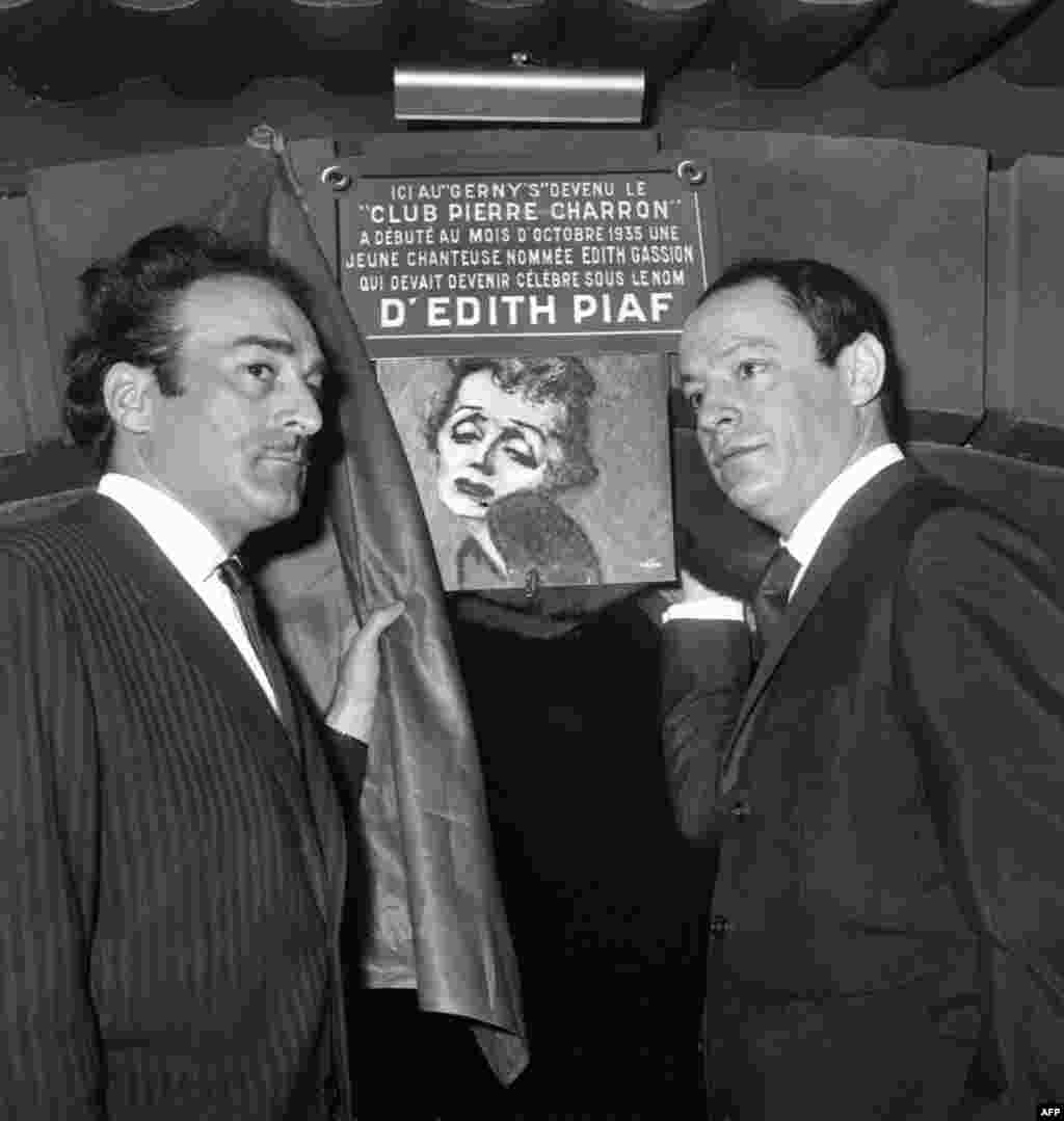 Michel Rivegauche and Charles Dumont, former lyricists and composers for Piaf, unveil a plaque in memory of the singer on February 8, 1966 at a Paris club -- the former cabaret Le Gerny's -- where an unknown singer named Edith Gassion debuted in 1935 and quickly became famous under the name "Mome Piaf."