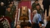 Mourners paying their respects to convicted war criminal Ratko Mladic at a church in Belgrade