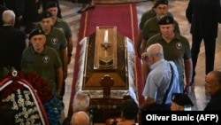Mourners paying their respects to convicted war criminal Ratko Mladic at a church in Belgrade