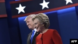 U.S. Republican presidential nominee Donald Trump (left) and Democratic presidential nominee Hillary Clinton arrive on stage for the first presidential debate at Hofstra University in Hempstead, New York, on September 26.