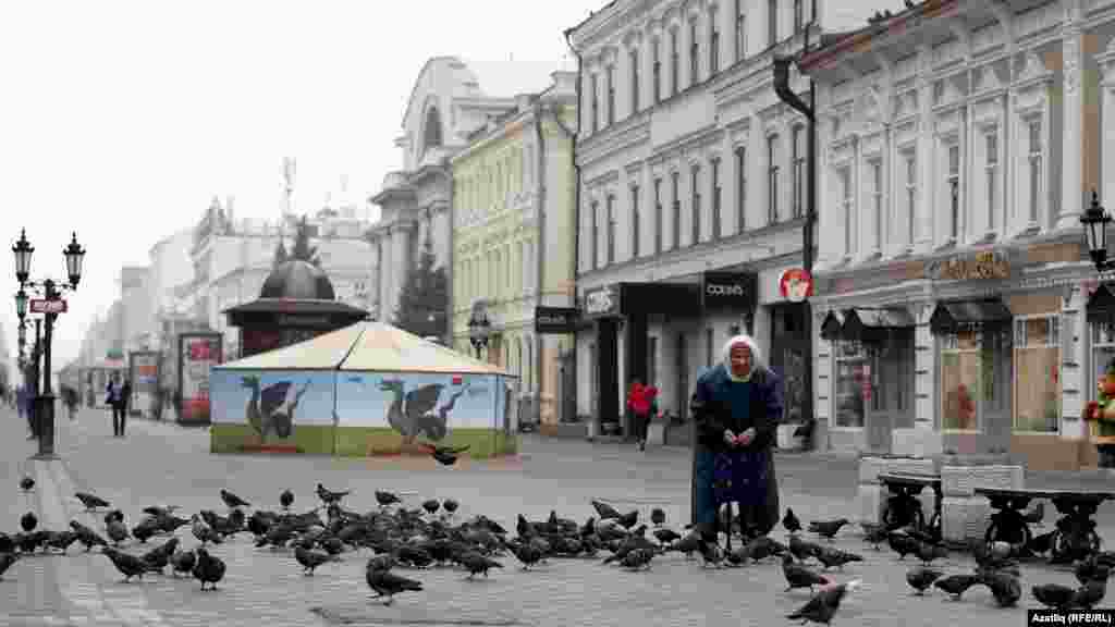 A woman feeds pigeons in Kazan, the capital of the Russian republic of Tatarstan.